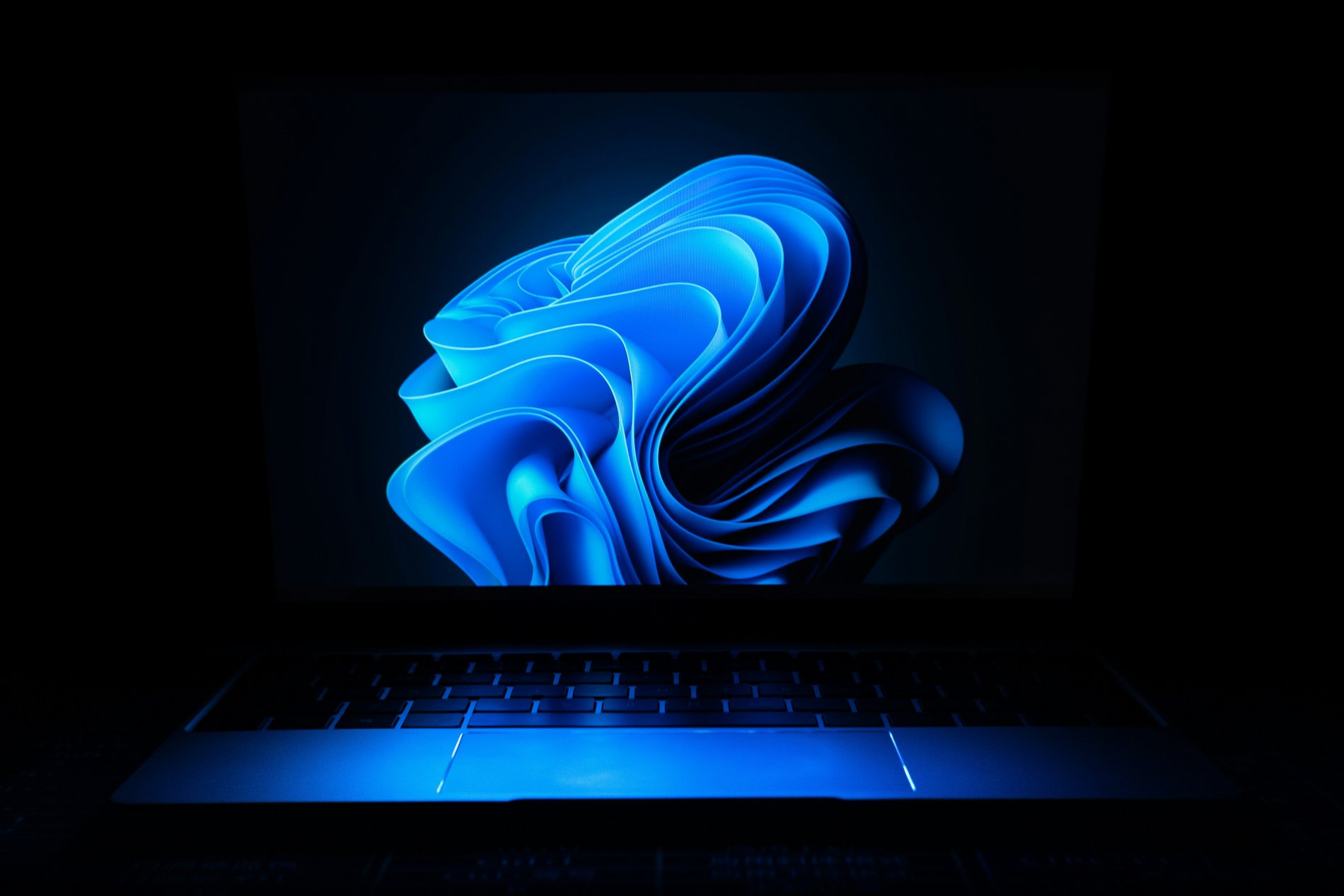 laptop with a blue swirl wallpaper